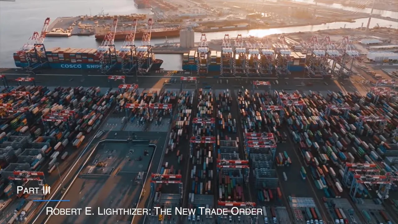 Aerial view of a container ship and cargo port with stacked shipping containers