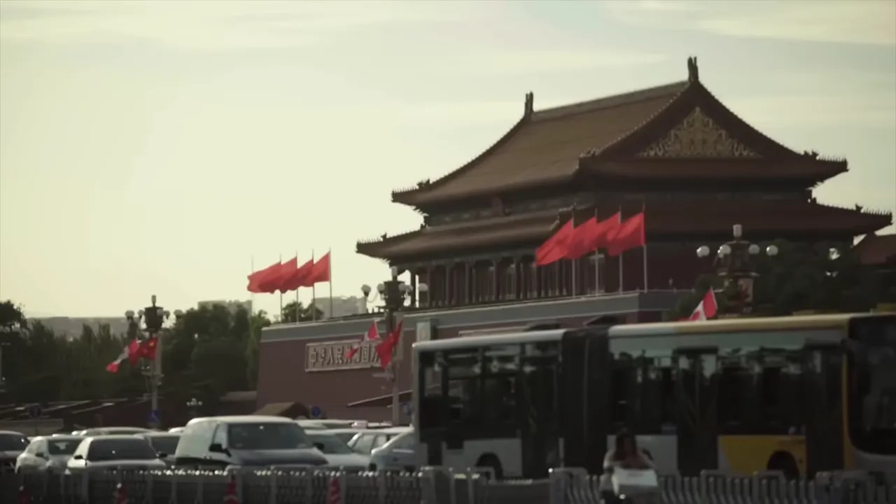 View of a Beijing government building with Chinese flags in the background