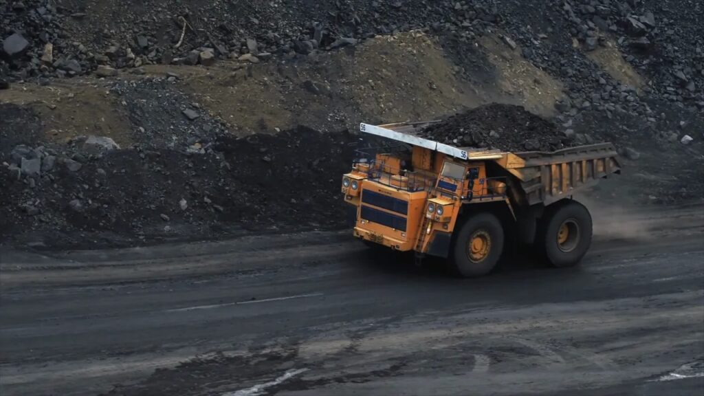 Heavy dump truck hauling material at a coal or mining site
