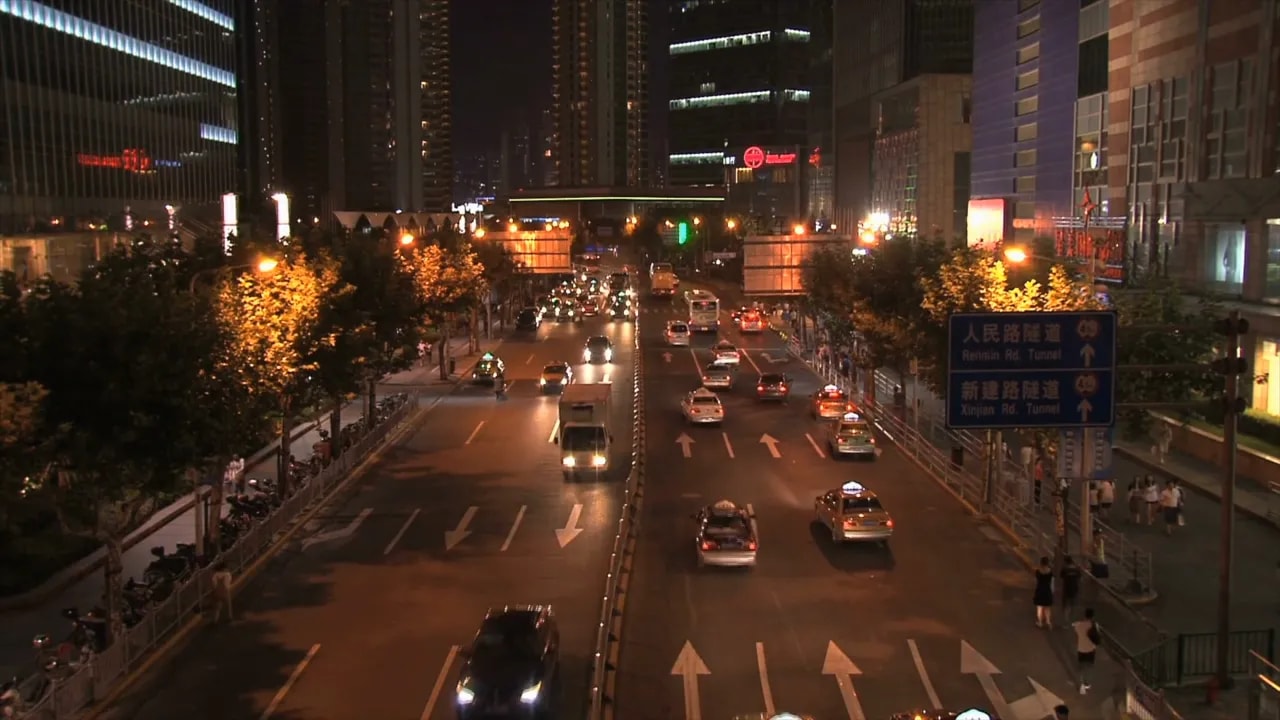 Nighttime traffic scene on a Beijing downtown street near tall office buildings