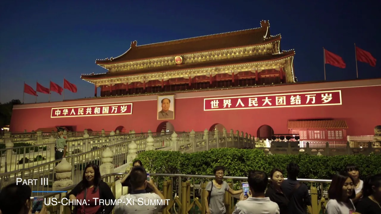 Nighttime view of Beijing Tiananmen gate with flags in front ahead of the Trump–Xi summit