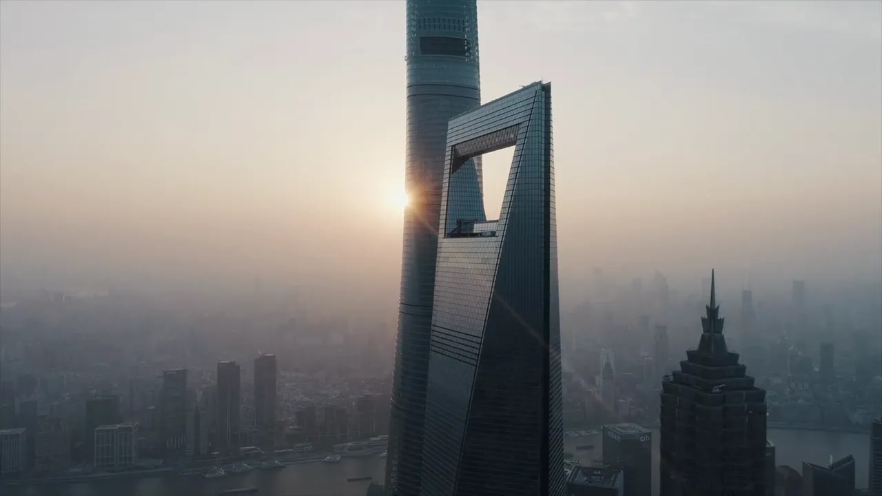 Shanghai skyline featuring modern towers and the river at sunset haze
