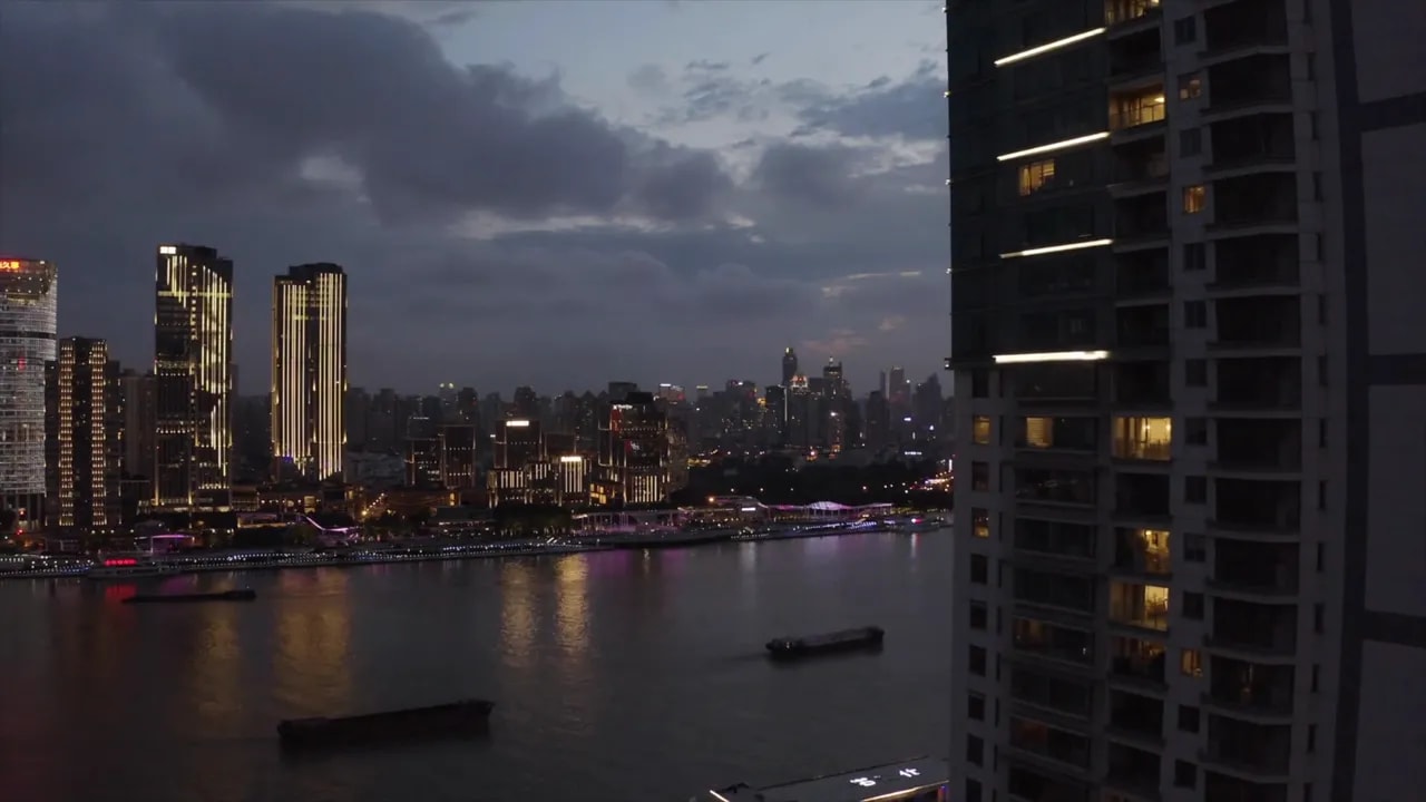 Shanghai skyline at dusk with river and illuminated buildings