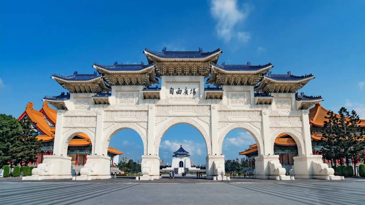 Traditional Chinese arch gate under a blue sky representing Taiwan tensions context
