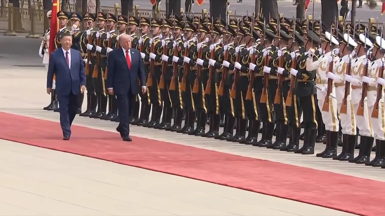 Donald Trump and Xi Jinping walking past an honor guard during a ceremonial welcome in Beijing