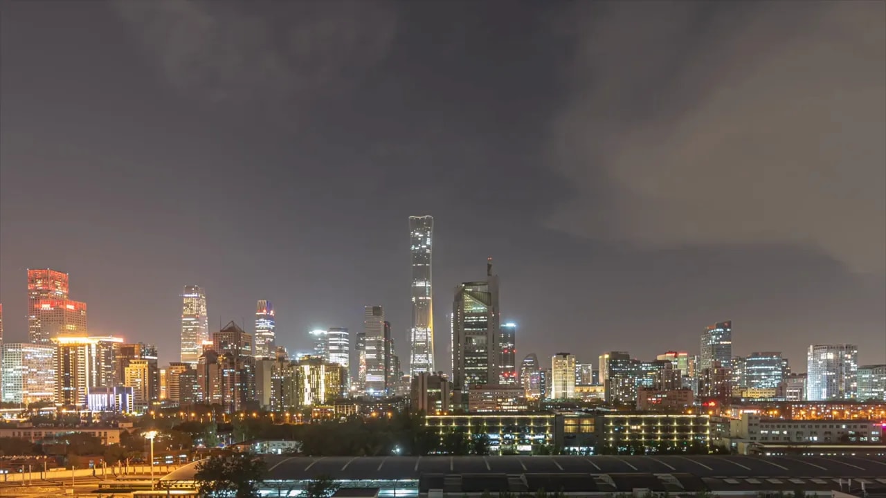 On-screen segment discussing Beijing land sales and property market weakness