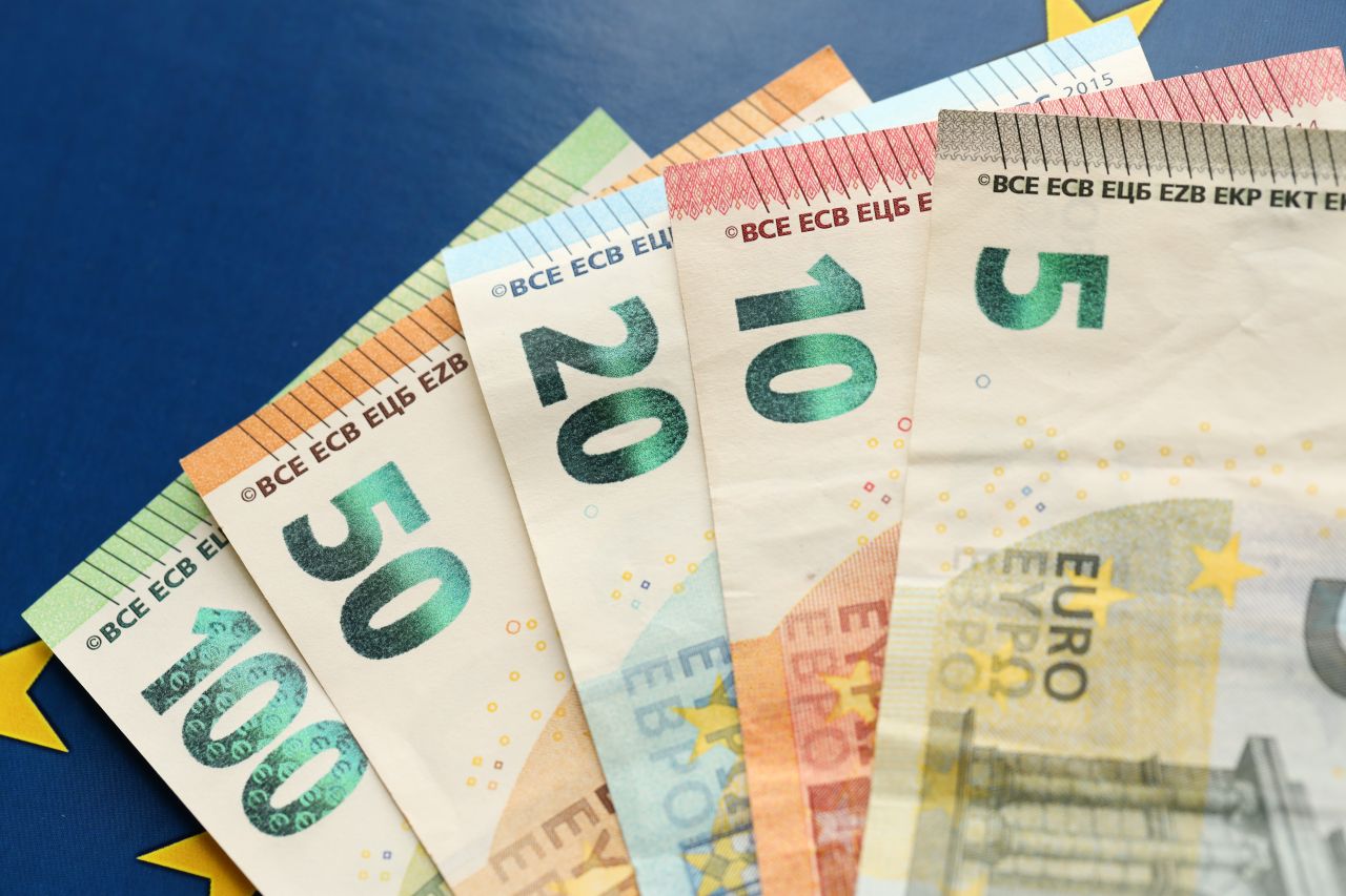 euro currency displayed on blue and gold flag s