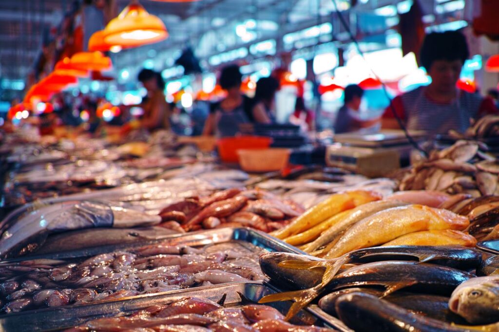 fresh seafood and customers at a fish market s