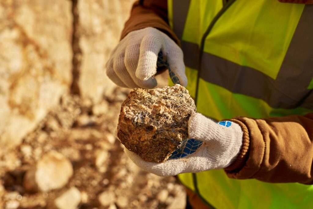 rare earth geologist inspecting rock specimen in quarry s jpg