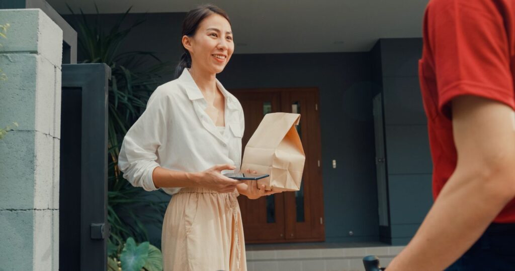 a china woman receiving food delivery at home by gig worker s