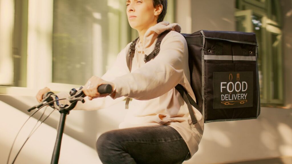 gig worker as food courier and riding bike s