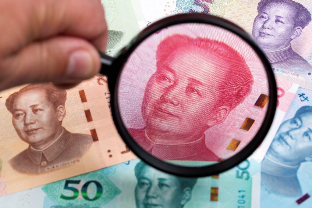 magnifying glass focuses on currency tax for overseas chinese s