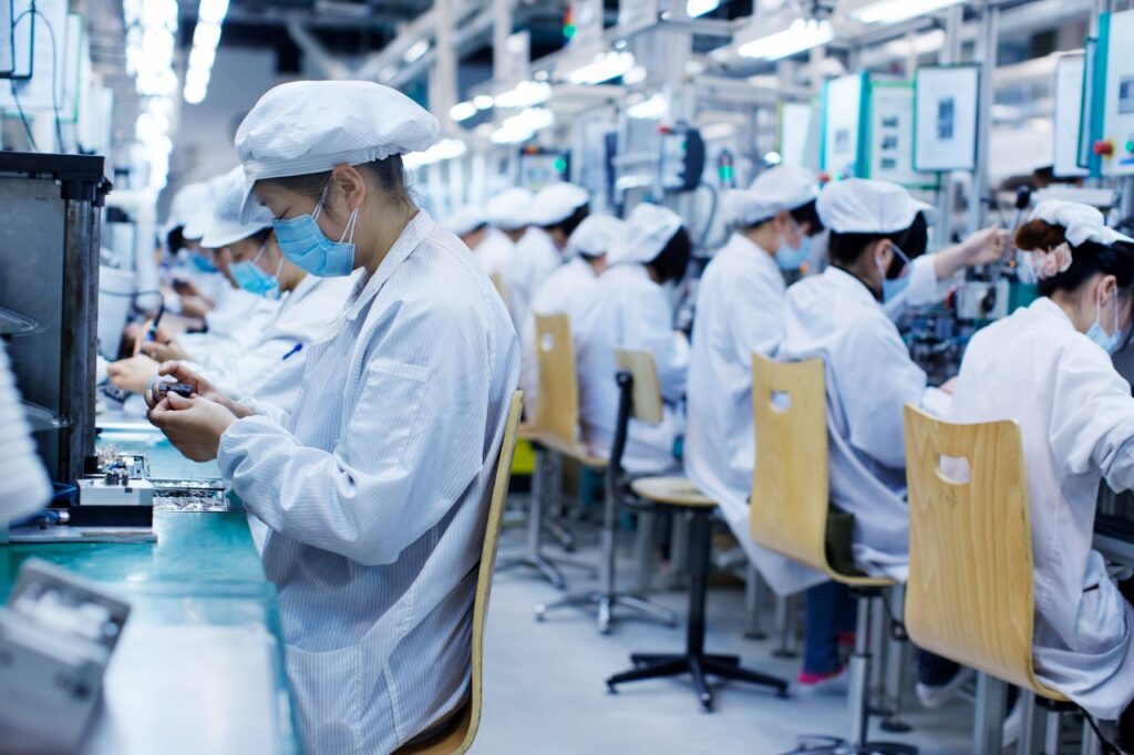 group of workers at small parts manufacturing china over production s