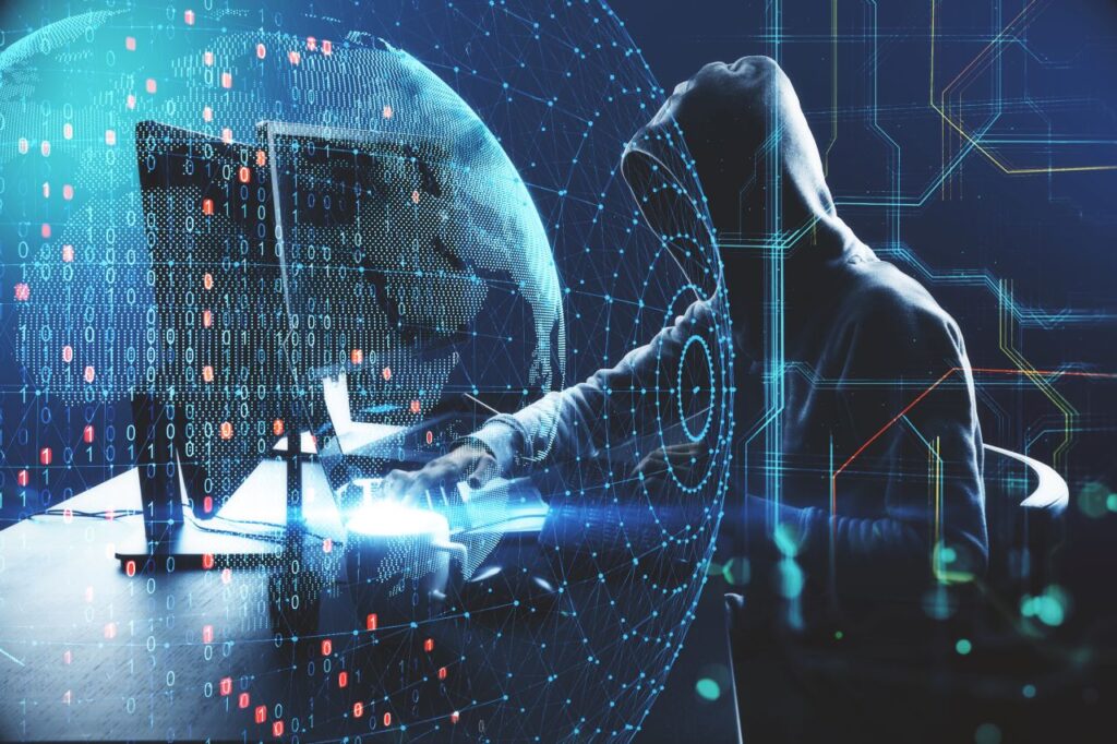 hacker in a hooded sweatshirt with computer code