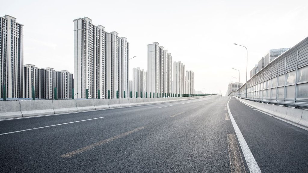china road with modern buildings in the background