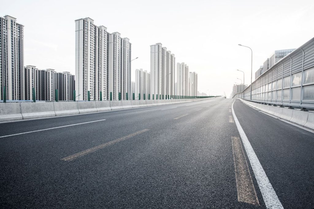 china road with modern buildings in the background
